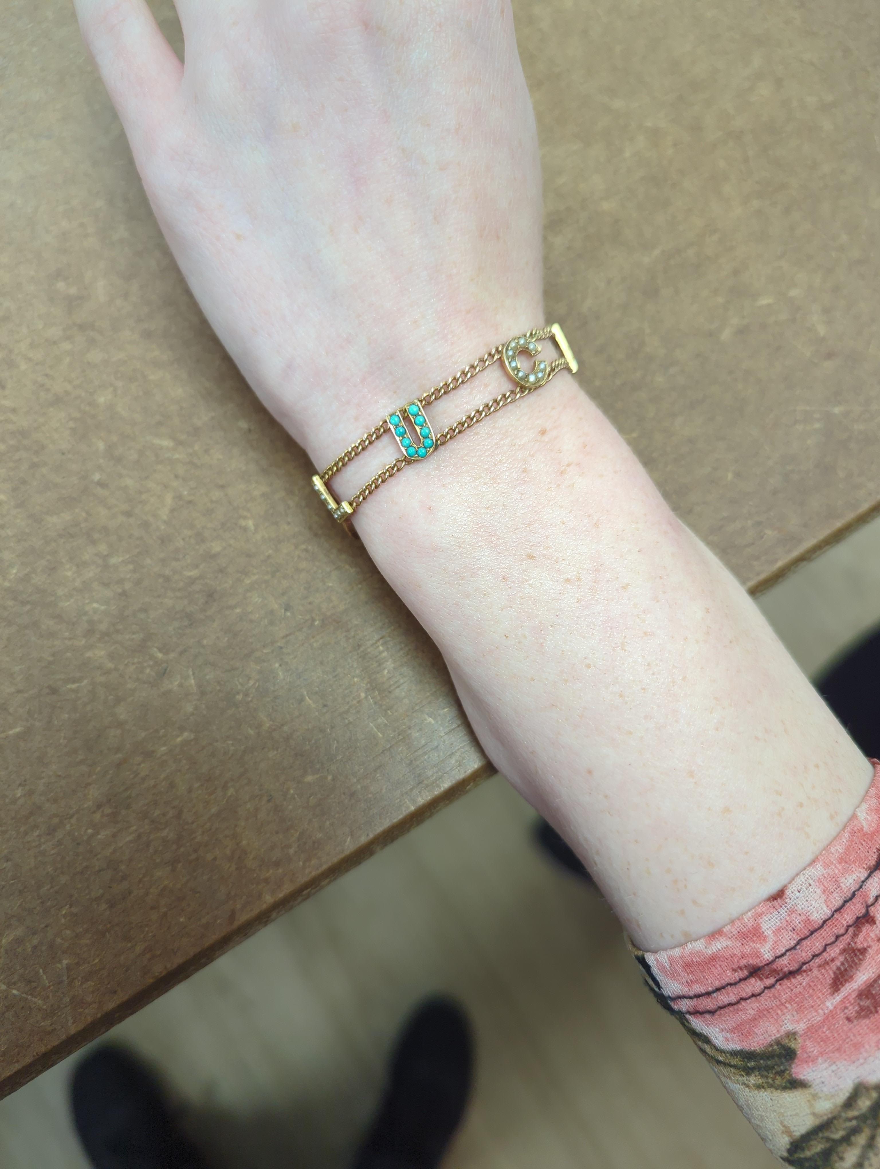 An Edwardian 15ct?, turquoise and seed pearl set 'Good Luck' chain bracelet, 17cm and a yellow metal and seed pearl set 'Baby' bar brooch.